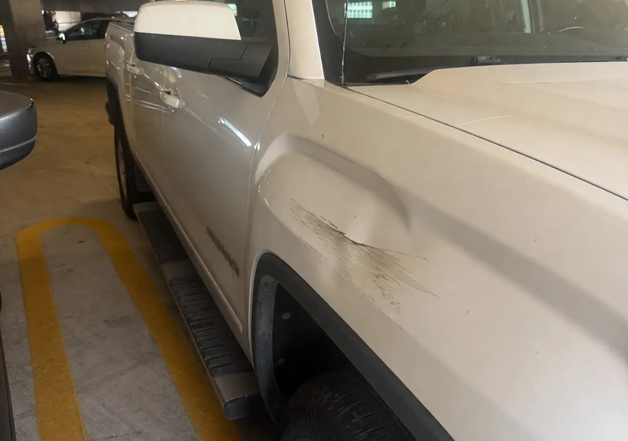 GMC Sierra front fender dent and scrape before repair